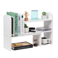 a white shelf with books and other items on it