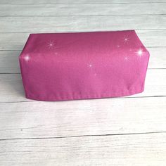 a pink box sitting on top of a wooden floor