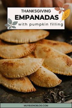 thanksgiving empanadas with pumpkin filling on a baking sheet and title overlay reads, thanksgiving empanadas with pumpkin filling