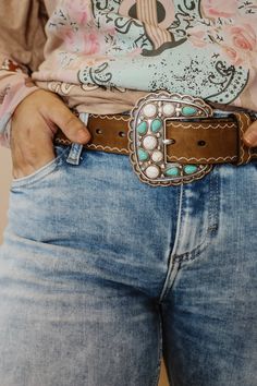 Angel Ranch Ladies belt by M&F Western Products. Genuine leather body accented with antique silver rectangle conchos that have turquoise and white stones. The outer edge of the conchos and stones are trimmed in antique copper for a beautiful accent. Available in sizes S-XL. Details Angel Ranch Ladies Belt Brown Sizes: S, M, L, XL Width: 1-1/2 Genuine Leather Scalloped Conchos with Turquoise and White Stones Matching Buckle Design Turquoise Shoes Outfit, Big Belt Buckle, Western Belts For Women, Buckle Display, Buckles Belt, Turquoise Jewelry Outfit, Country Belts, Turquoise Shoes, Womens Belt Buckles