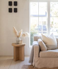 a living room filled with furniture and a window