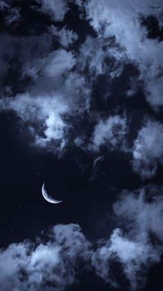 the moon is in the dark sky with some clouds around it, and there is no image here to provide a caption for