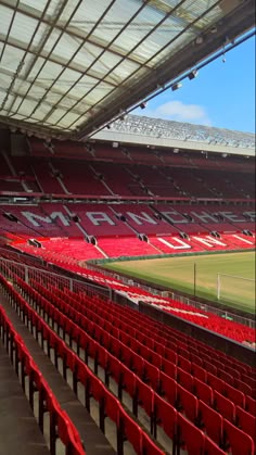 an empty soccer stadium with red seats