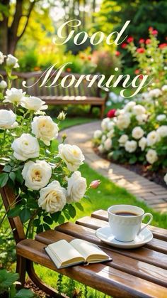 a cup of coffee sitting on top of a wooden bench next to white roses and a book