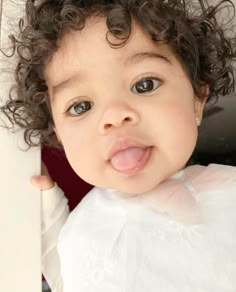 a close up of a child with curly hair