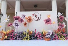 flowers are arranged in front of a building with the letters u and l on it