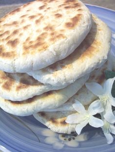 three flat breads stacked on top of each other on a blue and white plate