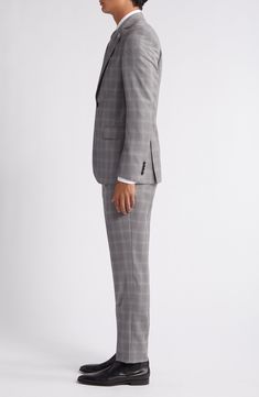 Grey Italian wool woven in a chalky plaid distinguishes a suit that's styled with traditional detailing to make it a smart addition to any formal wardrobe. Jacket has notched lapels; four-button cuffs; chest pocket; flap pockets; side vents Trousers have zip fly with button-tab closure; slant pockets; back button-welt pockets Jacket is lined Unhemmed 100% wool Dry clean Made in Canada Classic Plaid Suits For Workwear, Plaid Suiting Fabric Suits For Workwear, Formal Fitted Plaid Blazer, Plaid Suiting Fabric Suit For Workwear, Timeless Plaid Suits For Work, Fitted Timeless Plaid Suit, Classic Plaid Suit And Tie Accessories For Work, Timeless Plaid Suit For Work, Timeless Plaid Suits For Formal Occasions