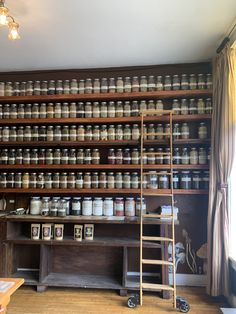 an old wooden shelf filled with lots of jars