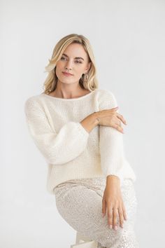 "This white mohair pullover was designed to be both luxurious and stylish. It combines the simplicity of knitwear with the coziness of alpaca wool and the fluffiness of mohair, making it an ideal addition to any outfit, whether you're dressed up for a formal event or having a party, or dinner with friends. DETAILS - Handmade. Our skillful knitters knit each garment by hand in their own homes and we are happy to provide them with the opportunity to support themselves while doing something they love. - White color. You can choose any other color listed in the last photo. - Composition: Alpaca wool, Lambswool, Mohair, Silk. No synthetic blends, for you and the environment. - Slightly oversized. The model wearing size M and she is 172 cm/5'6\" tall. - Alterations and Petit sizes are available. Pull Mohair, Orange Pullover, Mohair Jumpers, Mohair Knit, White Jumper, Fluffy Sweater, Dinner With Friends, Mohair Wool, Mohair Sweater