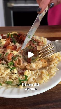 a person is cutting up some food on a plate with a knife and fork in it