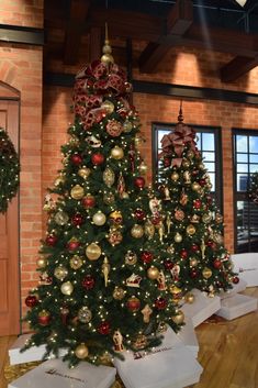 three christmas trees are decorated with red and gold ornaments