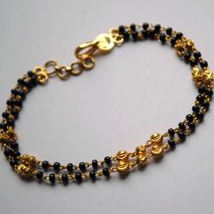 "Layered gold chain bracelet with black beads and gold balls, handcrafted with love and care, this is a very comfortable bracelet. A perfect accessory for everyday wear. Lightweight and stylish..! Available in single strand or double strand. * Length : 5.5\" to 9\" + 0.5\" extender eg : 6\" length will fit wrist size of 6\"- 6.5\" * Gold : 18k Solid Yellow Gold * Gold Weight - 4.5 gms approx for 6\" inches double strand with extender - For longer/shorter length, please ask for a quote before pla Black Bracelet With Gold Beads, Handmade Gold Chain Bracelet With Round Beads, Black Beaded Chain Bracelet For Gift, Gift Black Beaded Chain Bracelet, Black Beaded Bracelets With Gold Beads For Gifts, Black Beaded Bracelet As Gift, Gold Bracelet Jewelry With Black Beads, Gold Bracelet With Black Beads Jewelry, Yellow Gold Bracelets With Black Beads For Gift