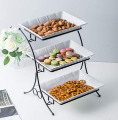 three tiered trays filled with different types of cookies