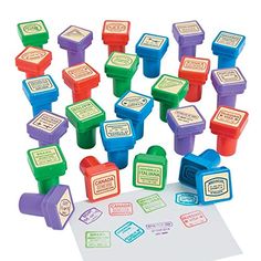 a bunch of stampers sitting on top of a white table next to a piece of paper