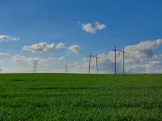 an empty field with power lines in the distance