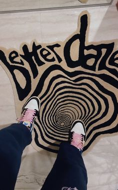 someone standing in front of a rug with the words better cake on it