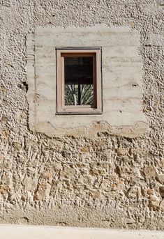 a window on the side of a stone building