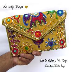 Golden Shoulder Bags - Girls Shoulder Bags Paisley Beautiful Woman Golden Bags Stylist Handbags Embroidery Gold Bags Purse Hand Clutch Traditional Bags Girls. An elegant and aesthetically handcrafted golden clutch bag for gorgeous ladies which can be used in any occasion, from a ravishing night party to a traditional wedding or just for daily purpose.  Product Dimensions Or Size: ♥ Width → 9 inches (22.86 cm) Approx. ♥ Length → 6 inches (15.24 cm) Approx. ♥ Strap Height/drop → 23 inches (58.42 cm)  Approx. ♥ Pattern → Shoulder Bag ♥ Color → Golden It is made by skilled Indian craftsmen with beautiful embroidery gold color bag and right velvet touch. The embroidered elephant is a symbol of peace, wisdom and grandeur. We Have made successful series of Bags for Regular, Casual and Formal uses Rectangular Handwork Bags For Daily Use, Rectangular Bags With Handwork For Everyday Use, Rectangular Bags With Multicolor Embroidery As Gifts, Trendy Embroidered Shoulder Bag As Gift, Embroidered Clutch Bag For Travel, Embroidered Clutch Bag For Everyday Use, Handmade Yellow Clutch Bag, Vintage Yellow Pouch Bag, Trendy Embroidered Pouch Bag