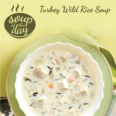 a bowl of chicken and dumpling soup on a yellow tablecloth with spoons