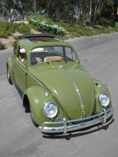 an old vw bug is parked on the street