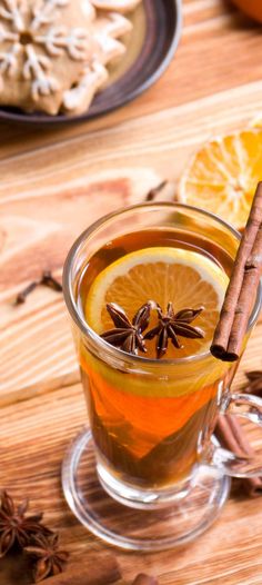 an orange and cinnamon drink in a glass mug