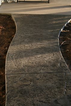 a man riding a skateboard down a cement walkway