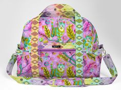 a multicolored floral print backpack with zippers on the front and shoulder straps