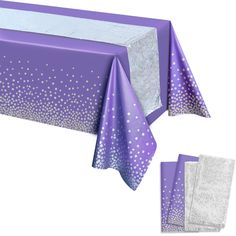 a purple table cloth with white dots on it and two napkins next to it