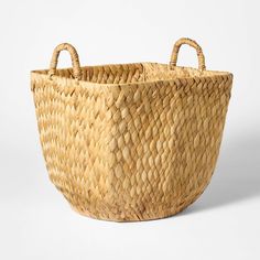 a woven basket with handles is shown on a white background