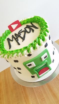 a birthday cake decorated with green and white frosting