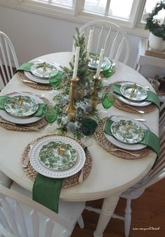 the table is set with green and white plates