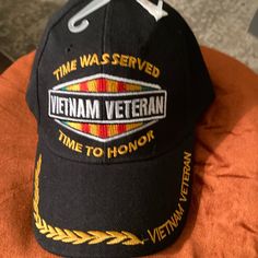 the vietnam veteran hat is on top of an orange pillow