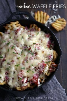 a skillet filled with cheesy baked potato fries and topped with melted cheese