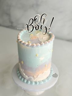 a blue and white cake sitting on top of a table