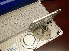 an open laptop computer sitting on top of a wooden desk next to a mouse and keyboard