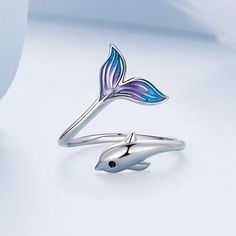 Immerse yourself in the playful world of the Lively and Smart Dolphin Ring, where a sprightly dolphin leaps gracefully out of the water, unveiling its mesmerizing blue-purple tail. This endearing design captures the essence of novelty and fashion, exuding a fresh and lovely aura that's as enchanting as the ocean itself. Gender: Women Style: TRENDY Size fit for: size 5-8 ( Circumstances: 49.3mm - 57mm) Shape\pattern: Animal Material: 100% 925 sterling silver Item Weight: 2.4g Item Type: Rings Aura Smart Ring, Dolphin Ring, Plain Rings, Ring Settings Types, Open Rings, Mood Ring, Animal Rings, Cute Rings, Birthday Gifts For Girls