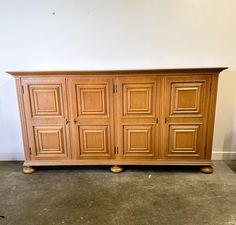 a large wooden cabinet sitting on top of a cement floor