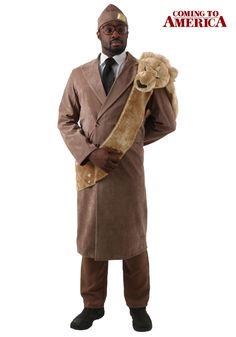 a man in a brown coat and hat is holding a teddy bear while standing with his hands on his hips