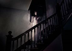 a ghostly person is walking down the stairs