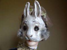 a close up of a mannequin wearing a veil and headpiece with hair