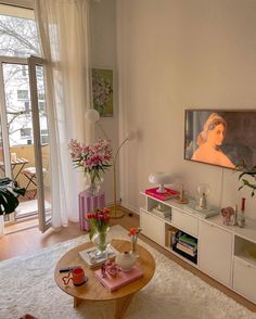 a living room filled with furniture and a painting on the wall next to a window