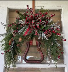 a christmas wreath hanging on the front door