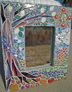 a decorative mirror sitting on top of a table