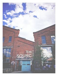 an old brick building with the words the source on it