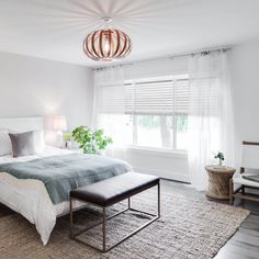 a bedroom with a large bed and white walls