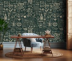 a chair and table in front of a wallpapered room with writing on it