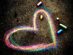 a heart made out of crayons on the ground with a quote from martin luther king