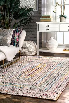 a white couch sitting next to a wooden table