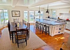 a large kitchen with an island table and chairs